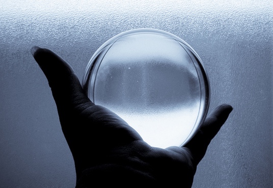 Crystal ball being held in hand in black and white